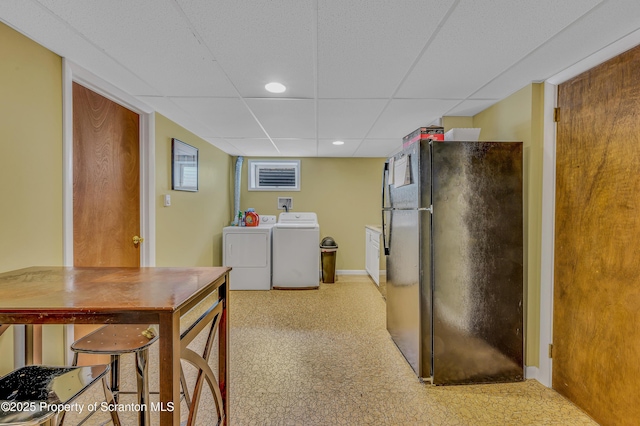 kitchen with washing machine and clothes dryer, a paneled ceiling, recessed lighting, freestanding refrigerator, and baseboards