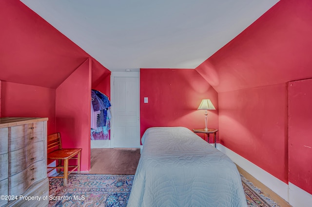 bedroom with lofted ceiling