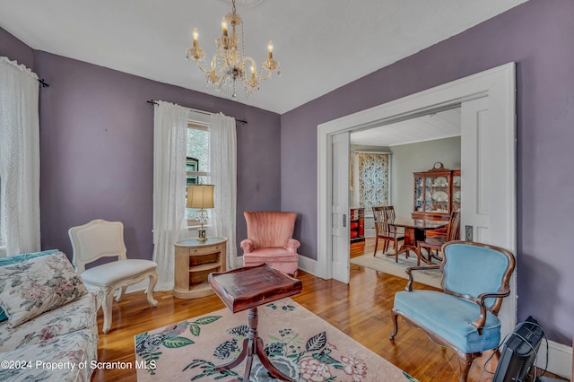 living area featuring a chandelier and light hardwood / wood-style flooring