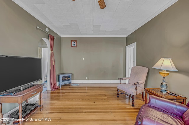 sitting room featuring wood-type flooring and ornamental molding