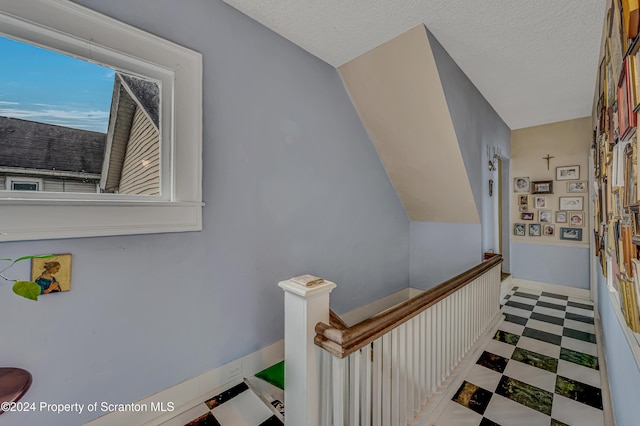 staircase with a textured ceiling