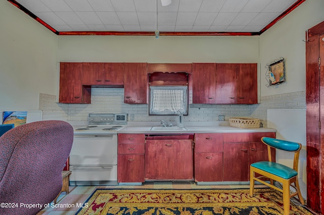 kitchen featuring crown molding, electric stove, and sink