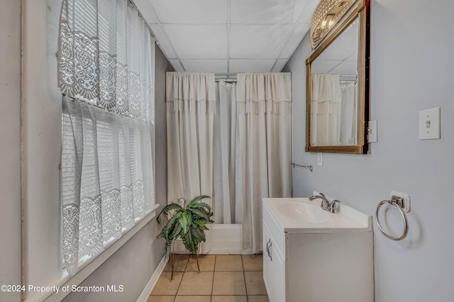 bathroom featuring tile patterned flooring, vanity, and a drop ceiling