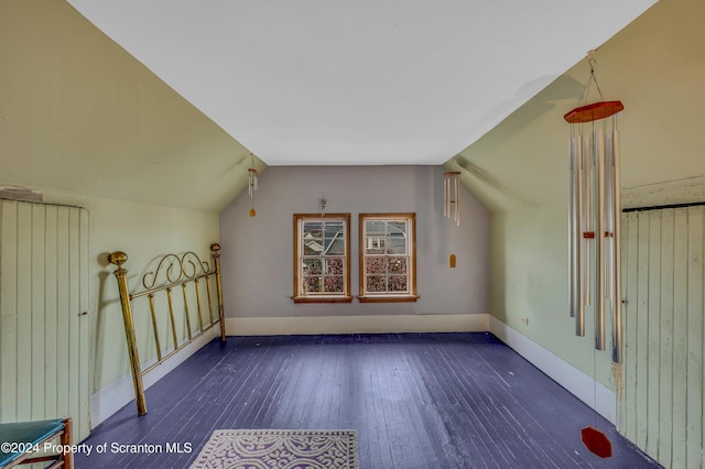 bonus room featuring dark hardwood / wood-style flooring and lofted ceiling