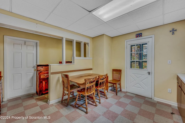 dining area featuring a paneled ceiling