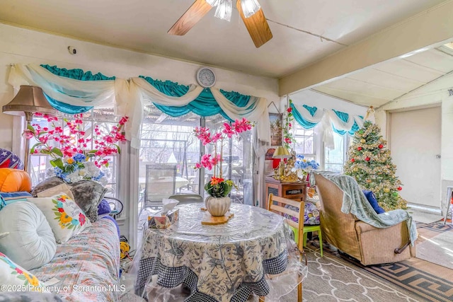 dining room with lofted ceiling with beams and ceiling fan