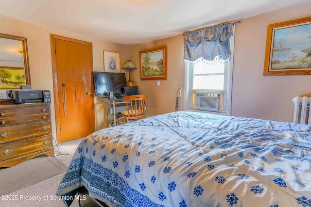 carpeted bedroom with cooling unit and radiator heating unit