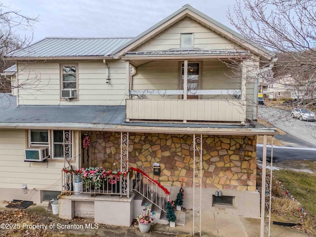 view of front of property with a balcony and cooling unit