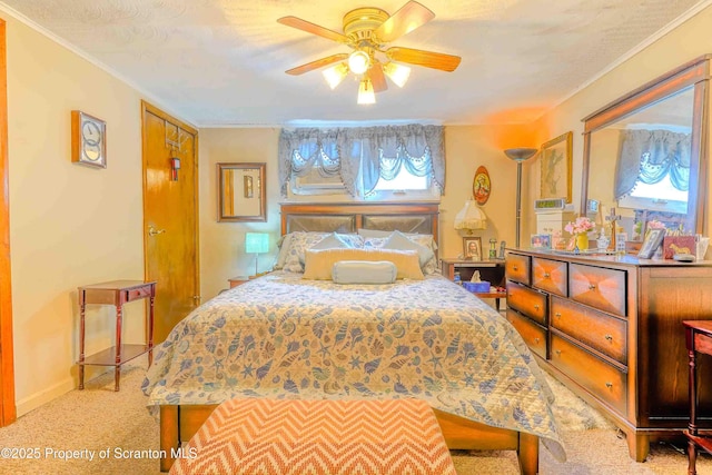 carpeted bedroom featuring ornamental molding and ceiling fan