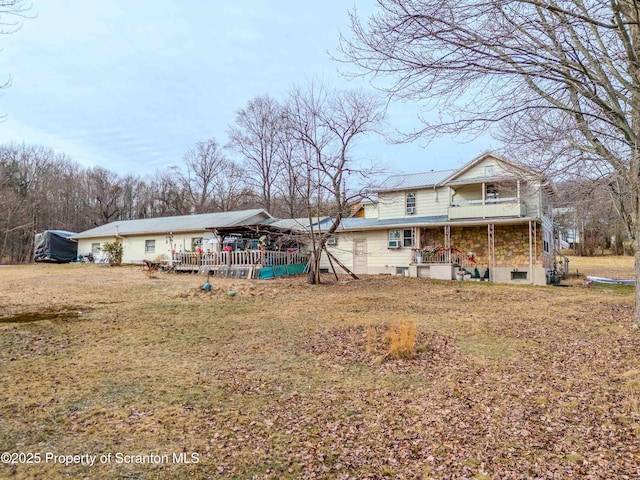 rear view of property featuring a yard