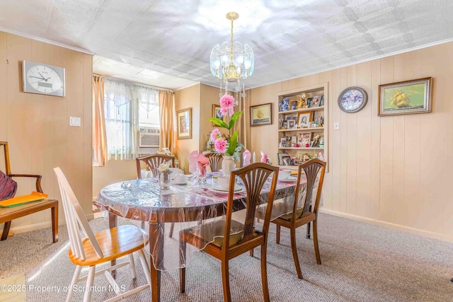 carpeted dining space featuring built in shelves, wood walls, cooling unit, and a notable chandelier