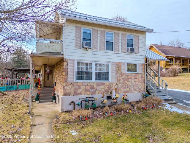 view of front facade with cooling unit and a front yard