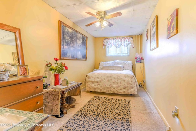 bedroom featuring light colored carpet and ceiling fan