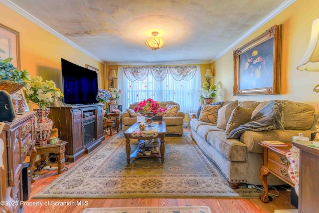 living room featuring hardwood / wood-style flooring and ornamental molding