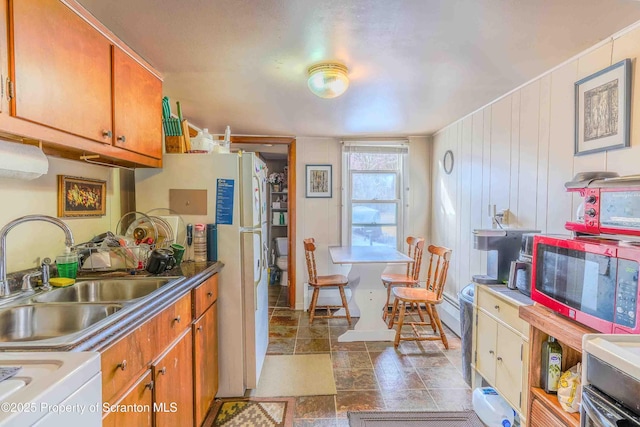 kitchen featuring sink and white fridge