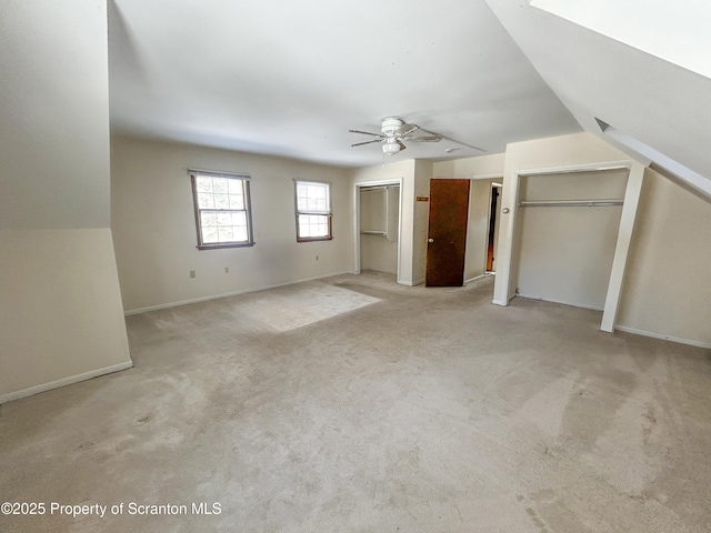 203 Willow Rd, Dalton, PA 18414 - unfurnished bedroom with multiple closets, baseboards, carpet, and a ceiling fan