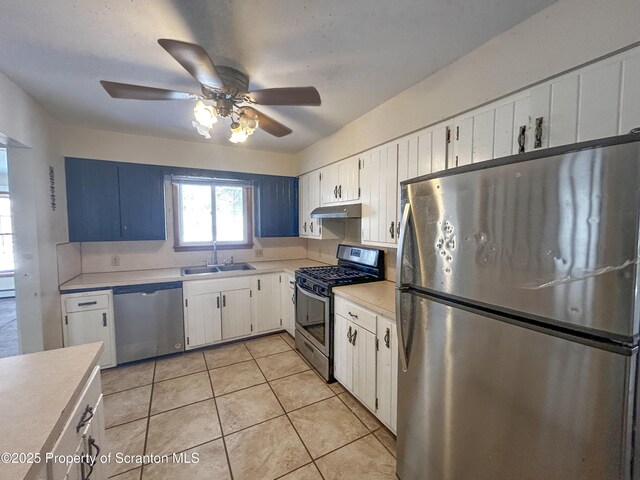 203 Willow Rd, Dalton, PA 18414 - kitchen featuring stainless steel appliances, a sink, light countertops, under cabinet range hood, and white cabinetry