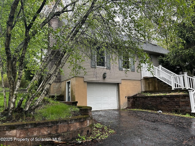 203 Willow Rd, Dalton, PA 18414 - view of front of property with asphalt driveway, an attached garage, and a chimney