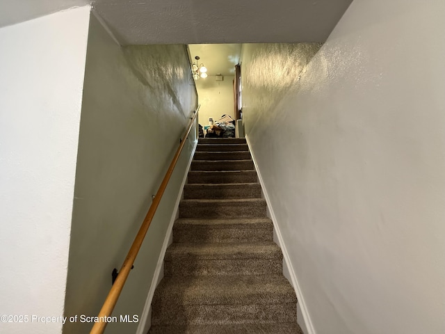 stairs featuring carpet floors and baseboards