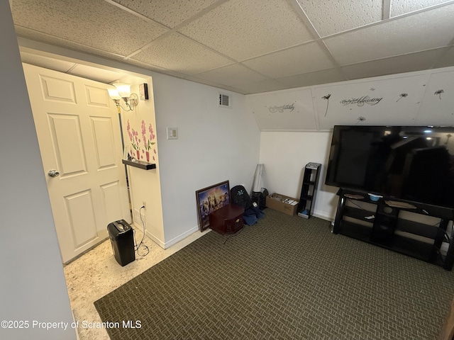 carpeted living room featuring a paneled ceiling, visible vents, and baseboards