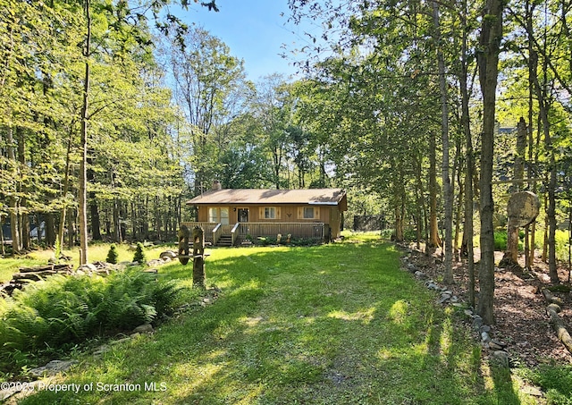 55 Lyman Ln, Gouldsboro, PA 18424 - view of green lawn featuring a deck and a view of trees