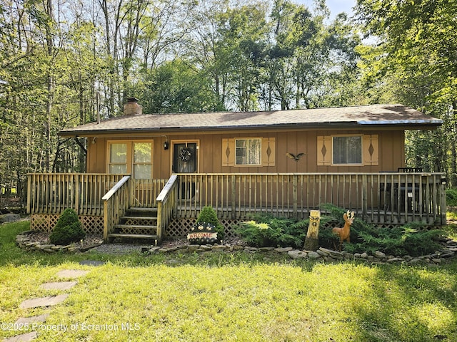 55 Lyman Ln, Gouldsboro, PA 18424 - view of front of property with a chimney, a front lawn, and a wooden deck