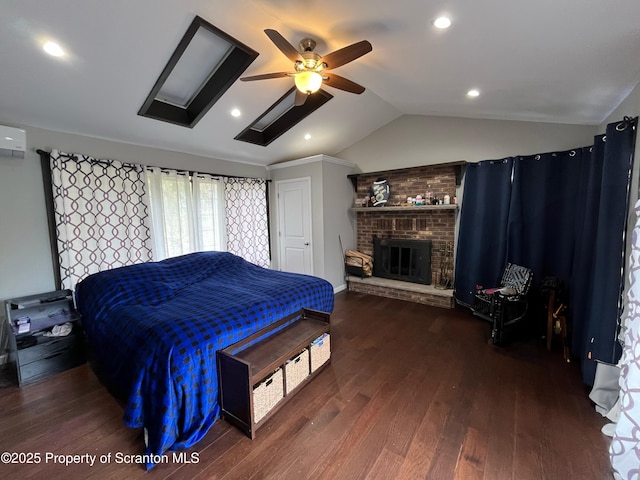 bedroom with vaulted ceiling, wood-type flooring, a fireplace, ceiling fan, and recessed lighting
