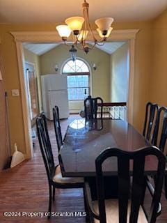 dining area with a chandelier and lofted ceiling