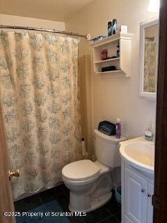 full bathroom with toilet, curtained shower, and vanity