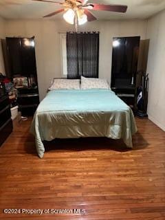 bedroom with hardwood / wood-style flooring and ceiling fan