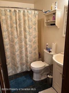 bathroom with walk in shower, tile patterned floors, vanity, and toilet