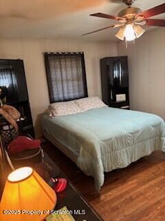 bedroom with wood finished floors and a ceiling fan