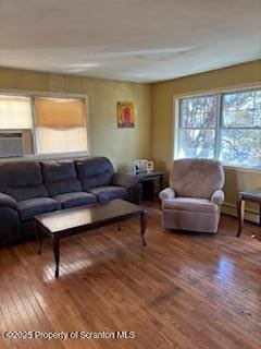 living area with wood finished floors and cooling unit