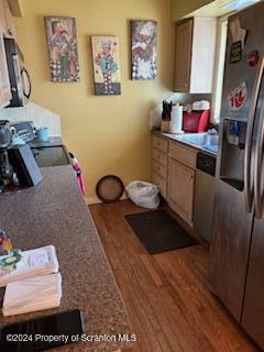 kitchen featuring appliances with stainless steel finishes and wood-type flooring