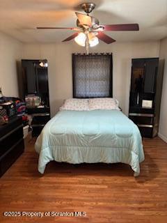 bedroom with wood finished floors and a ceiling fan