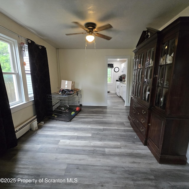 612 Ferdinand St, Scranton, PA 18508 - dining area with baseboard heating, a ceiling fan, and wood finished floors