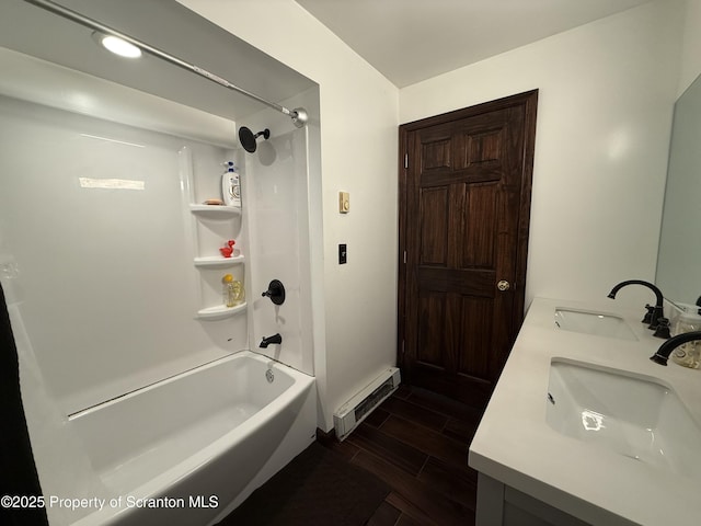 bathroom with a baseboard radiator, vanity, and shower / bathtub combination