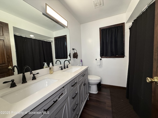 bathroom featuring vanity, toilet, and hardwood / wood-style floors