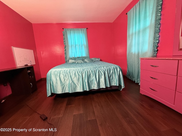 bedroom featuring dark wood-type flooring