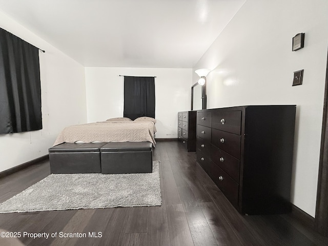 bedroom featuring dark hardwood / wood-style flooring