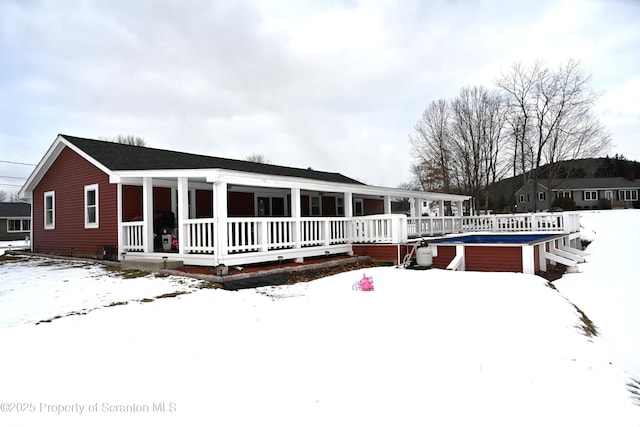 snow covered property featuring a porch