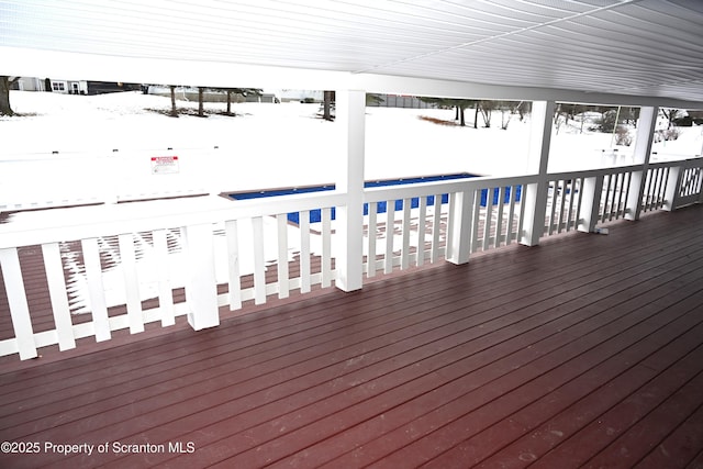 snow covered deck with a pool