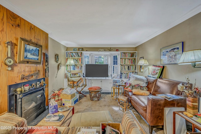 living room with crown molding, carpet floors, and a wood stove