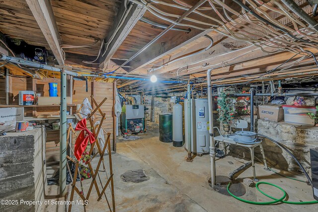 unfinished basement with water heater, a water softener, and a heating unit