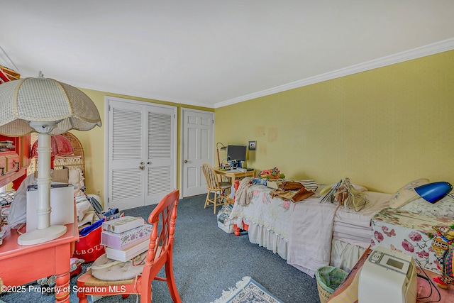 bedroom with carpet flooring, ornamental molding, and a closet