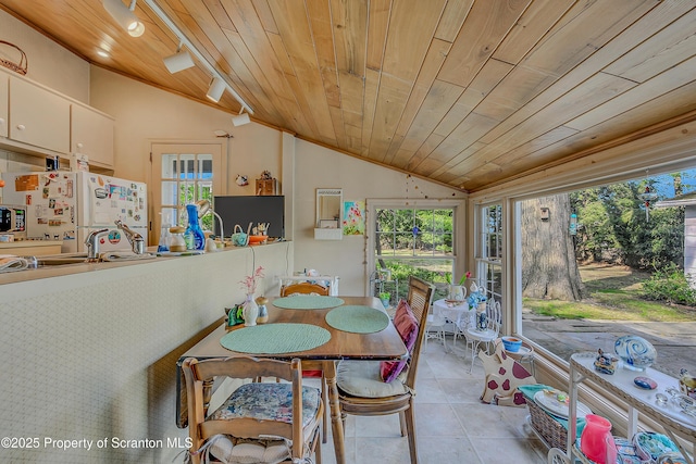 dining space with vaulted ceiling, wood ceiling, and light tile patterned floors