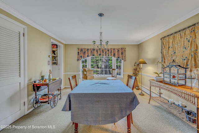 dining room featuring carpet, crown molding, and baseboards