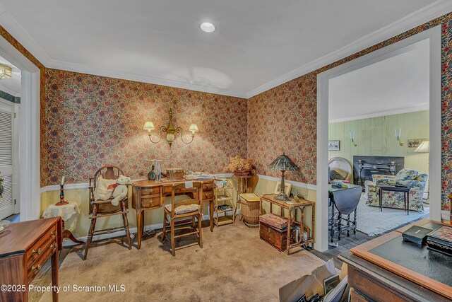 office space featuring carpet floors, crown molding, wallpapered walls, and a wainscoted wall