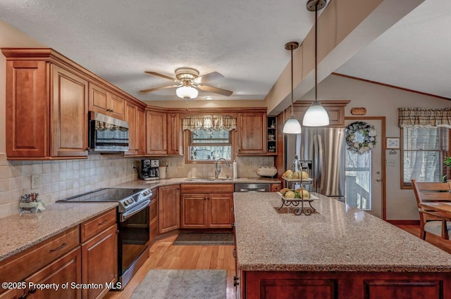 37 S Lehigh River Dr, Clifton Twp, PA 18424 - kitchen with appliances with stainless steel finishes, a sink, light wood-type flooring, brown cabinets, and decorative backsplash