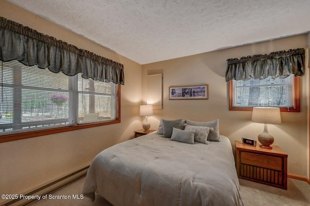 37 S Lehigh River Dr, Clifton Twp, PA 18424 - carpeted bedroom with a textured ceiling, multiple windows, baseboards, and a baseboard heating unit
